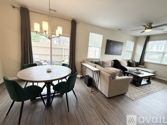 A living room with a dining table and chairs.