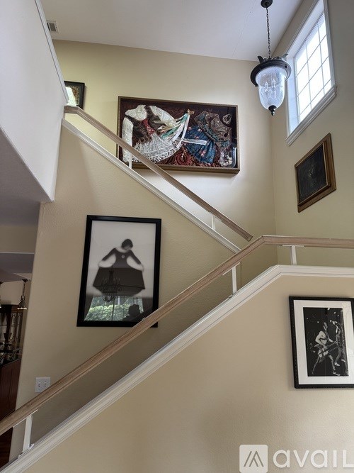A staircase with a painting of a woman on the bottom step.