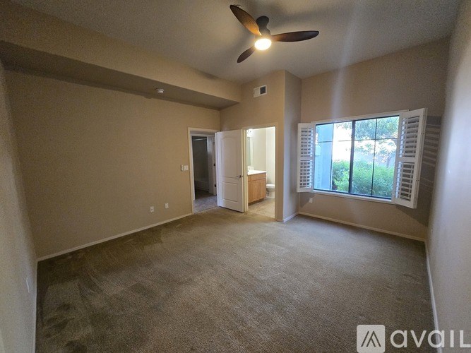 A room with wooden floors and a ceiling fan.