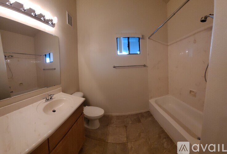 A bathroom with a sink, toilet, and bathtub.