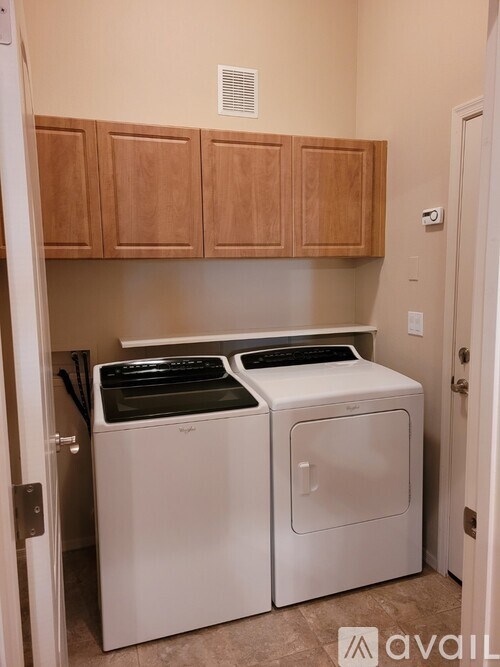 A small laundry room with a washer and dryer.