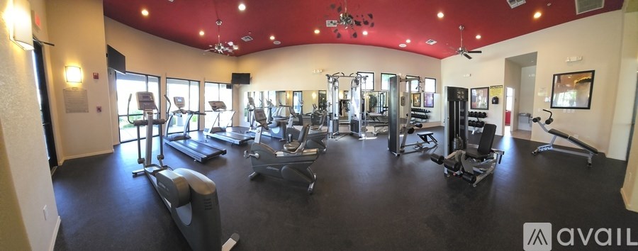 A spacious garage with white cabinets and a white door.