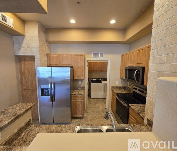 A kitchen with wooden cabinets and black appliances.