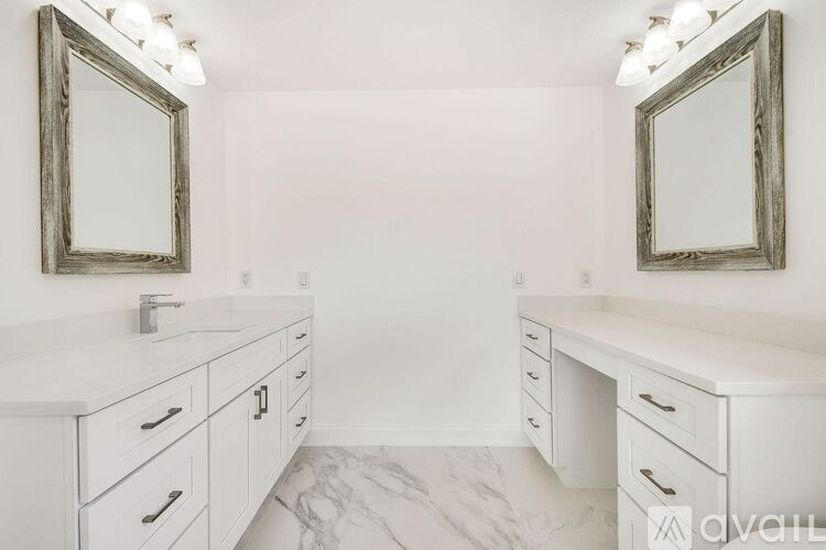 A bathroom with two sinks and two mirrors.