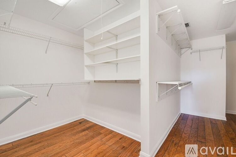 Empty room with wooden floors and white walls.