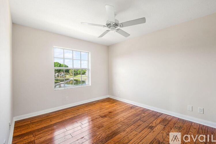 A room with a window and a fan.