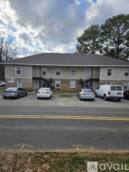 A building with a parking lot in front of it.
