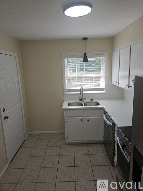 A small kitchen with a sink and a window.