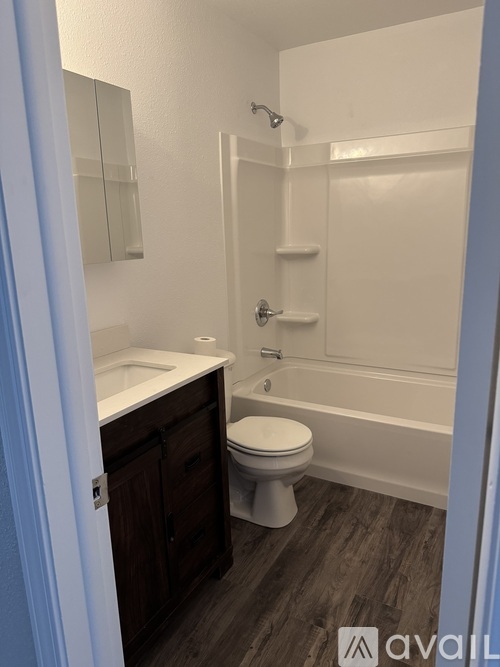 A bathroom with a toilet, sink, and bathtub.