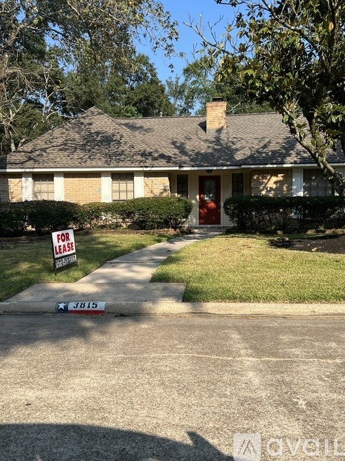 A house with a for lease sign in front of it.