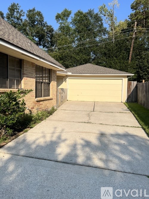 A house with a garage and a driveway in front.