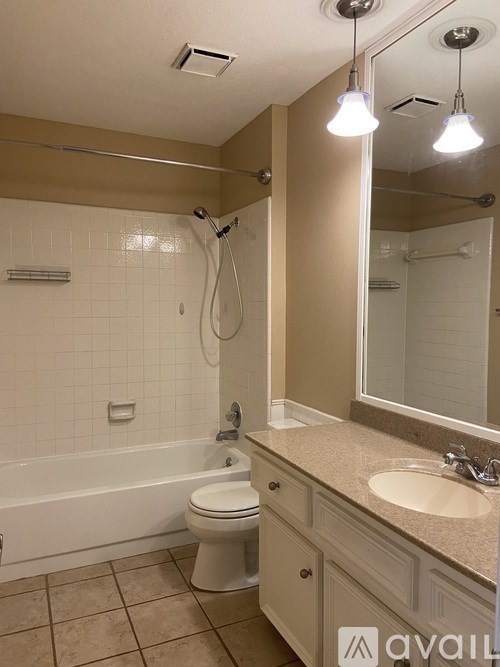 A bathroom with a toilet, sink, and bathtub.