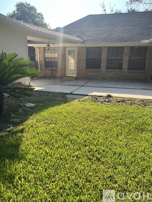 A house with a well-maintained lawn in front.
