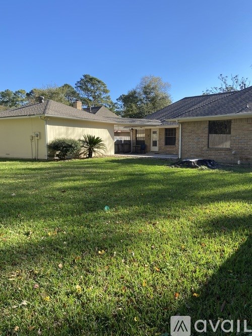 A house with a well-maintained lawn in front of it.