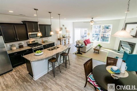 A modern kitchen with a large island and bar stools.