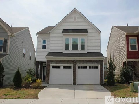 A two-story house with a garage is available for sale.