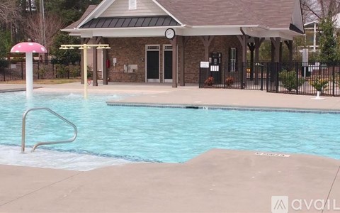 A pool with a building behind it.