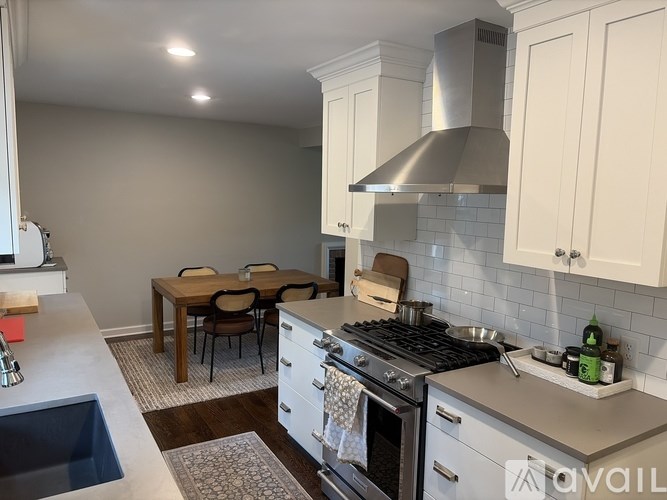 A kitchen with a table and chairs in the middle of the room.