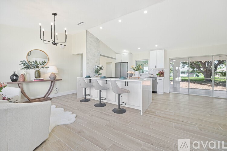 A modern kitchen with white cabinets and a large island.