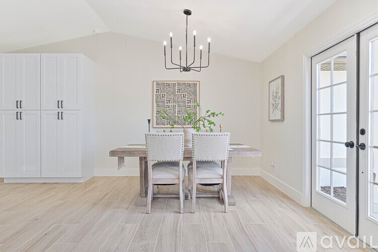 A dining room with a table and chairs.