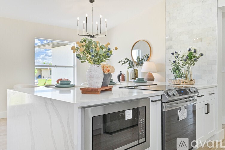 A kitchen with a white countertop and a stove top oven.