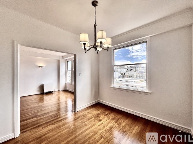 A room with wooden floors and a chandelier.
