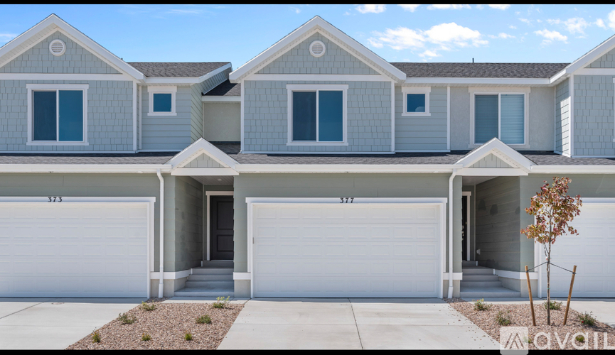 A row of houses with garages in front.