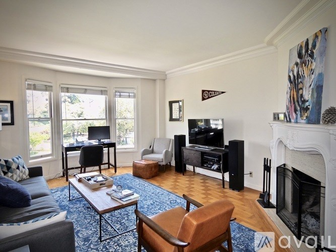 A living room with a fireplace and a television.