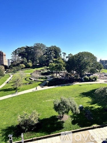 A park with a walking path and trees.