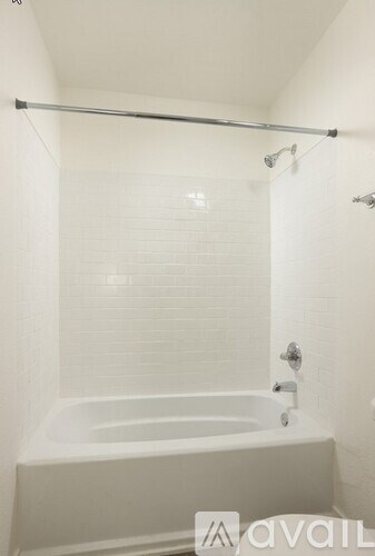 A white bathroom with a tub and shower.