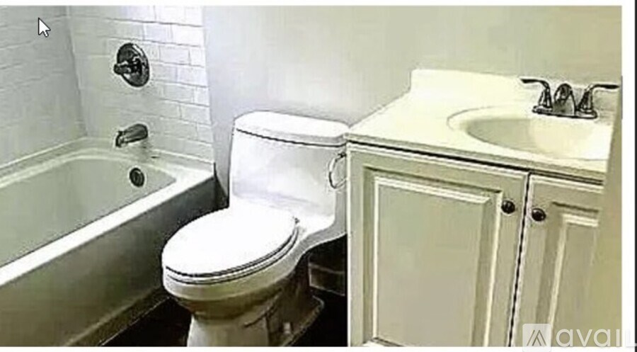A white toilet sits next to a sink in a bathroom.