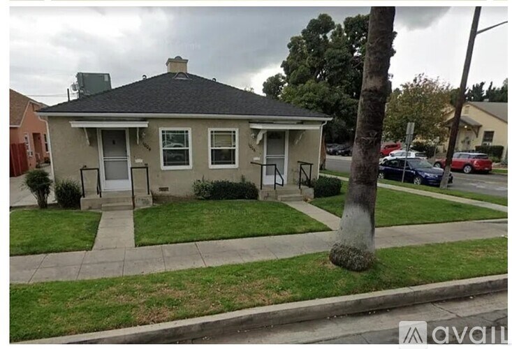 A house with a tree in front of it.