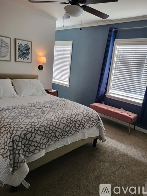 A white stove in a kitchen with a fire extinguisher on the wall.