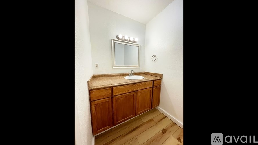 A wooden medicine cabinet with a mirror above it.