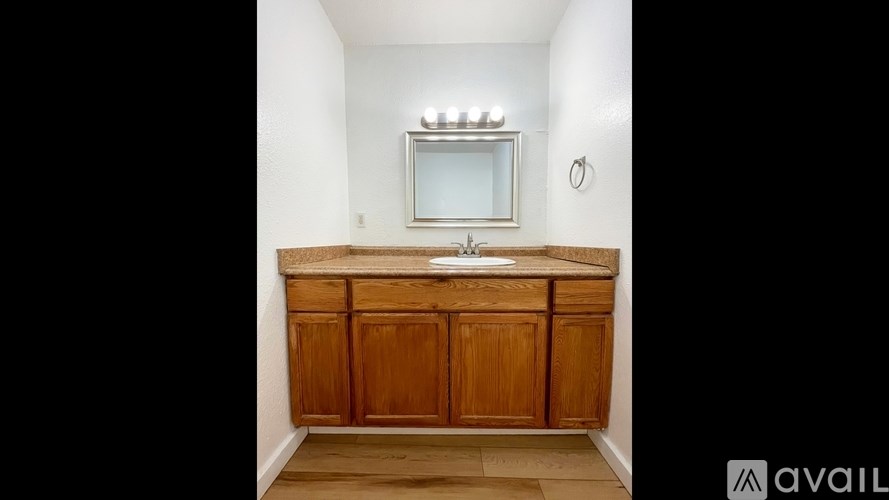 A wooden cabinet with a mirror above it.