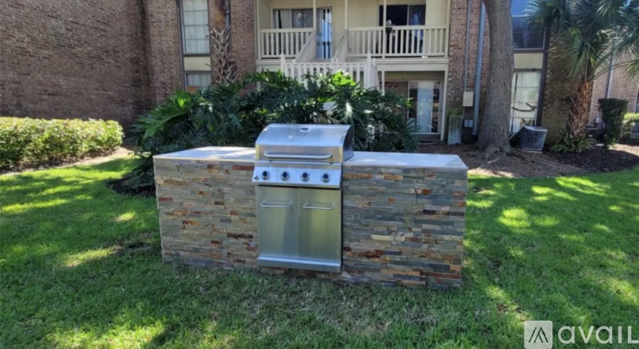 A stone wall with a metal box on top of it.