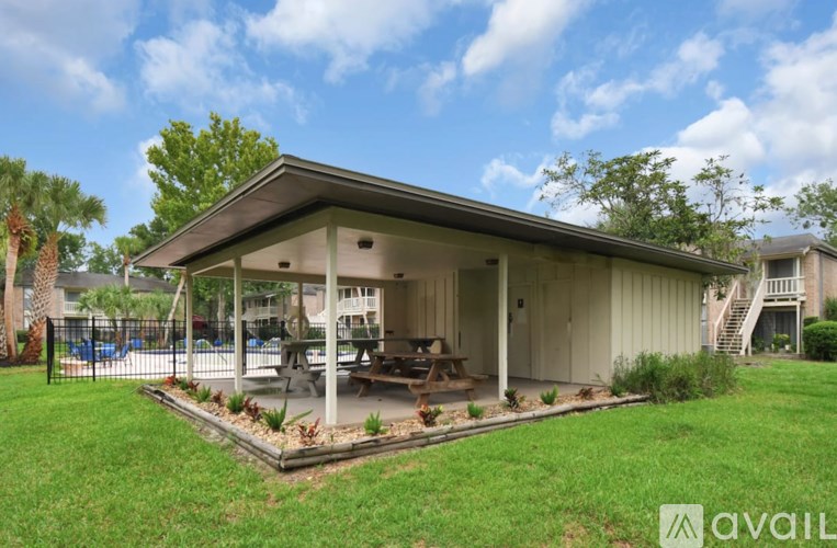 A covered patio area with a table and chairs is available for rent.