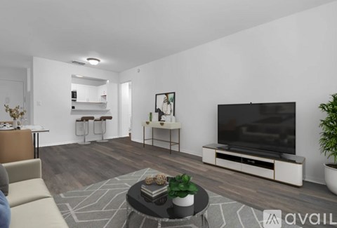 A modern living room with a large television and a coffee table.