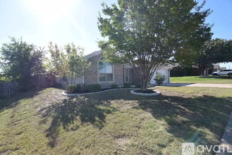 A house with a tree in front of it is for sale.