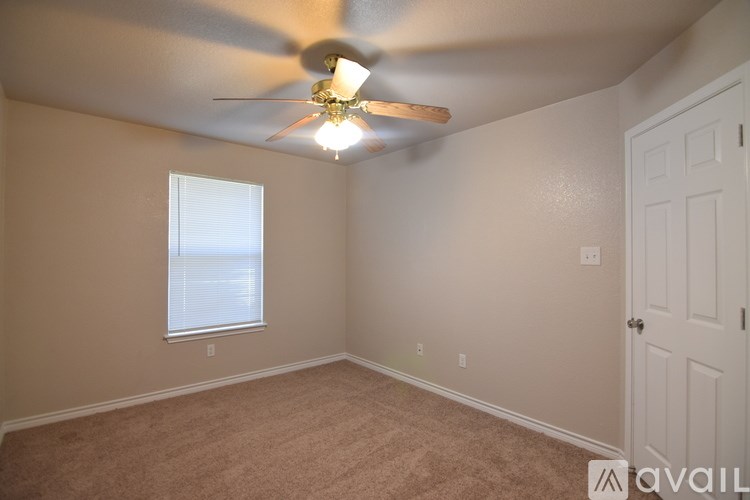A room with a ceiling fan and a window.