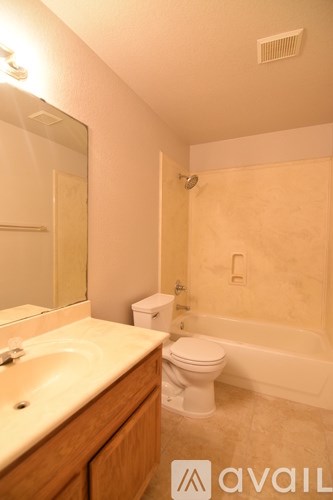 A bathroom with a toilet, sink, and bathtub.