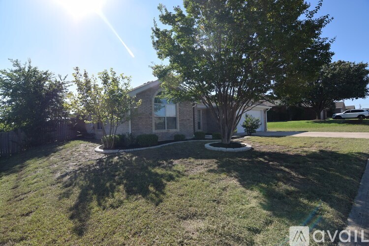A house with a tree in front of it is for sale.