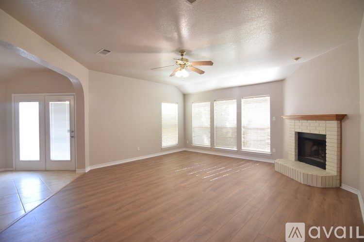 A spacious living room with a fireplace and sliding glass doors.