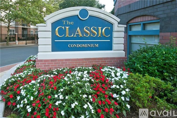 The Classic Condominium sign is displayed in front of a building.