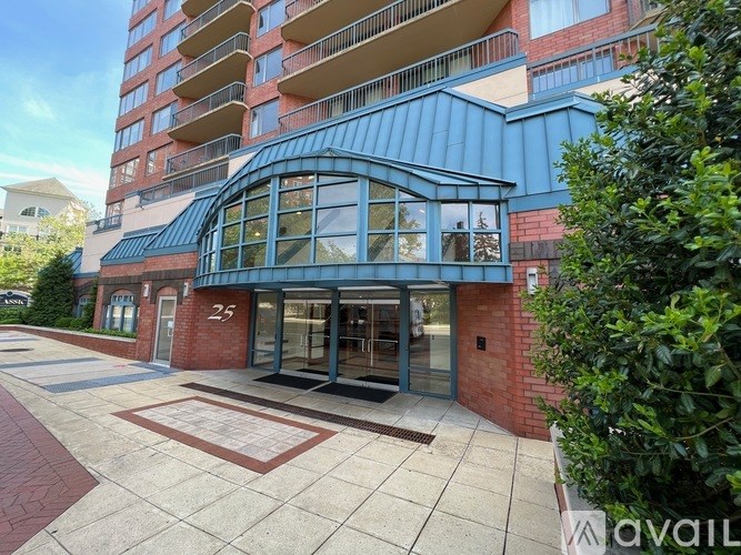 A modern building with a blue roof and glass doors.