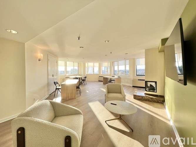 A living room with a white sofa and a fireplace.