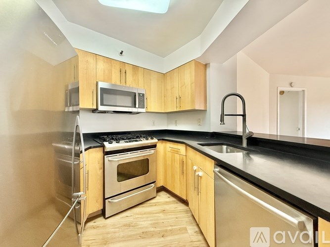 A kitchen with wooden cabinets and stainless steel appliances.