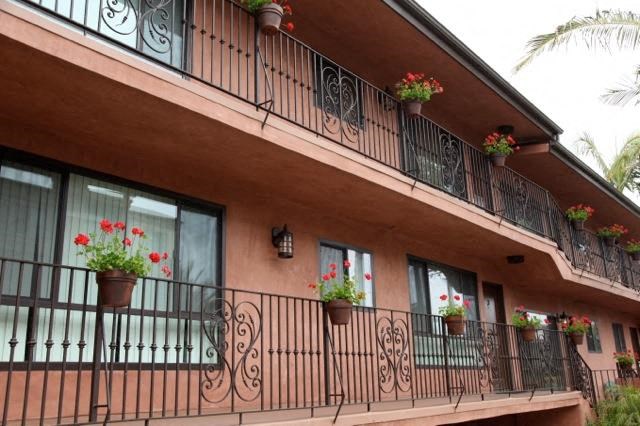 a building with flowers on the balcony