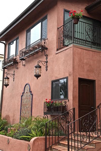 a building with a balcony and flowers on it