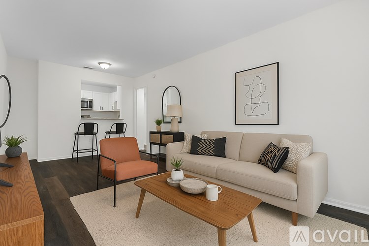 A living room with a couch, chairs, and a coffee table.